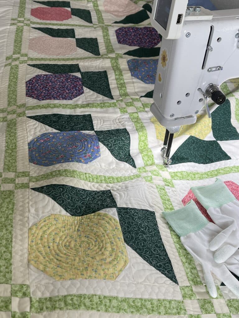 A machine is being used to sew a quilt.