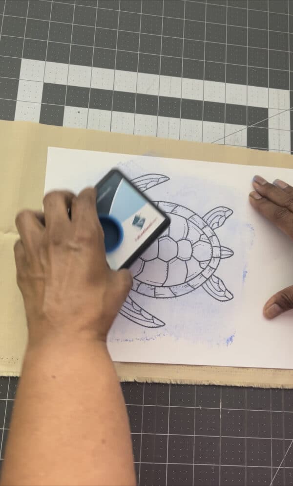 A person using an iphone to draw a turtle.