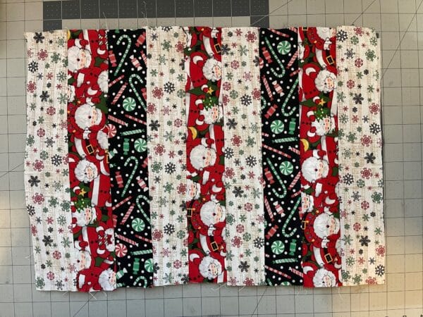 A close up of three quilted christmas table mats