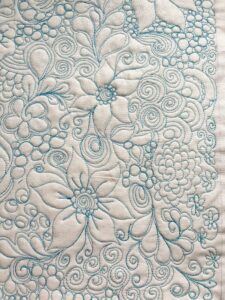 A close up of the blue and white floral pattern.