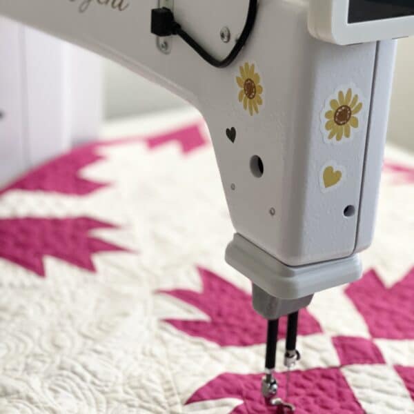 A sewing machine with a quilt on it.