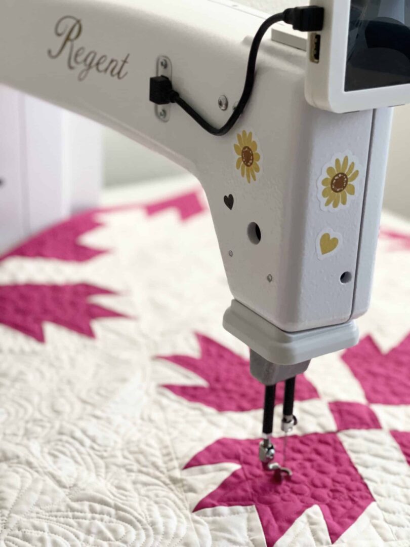 A sewing machine with a quilt on it.