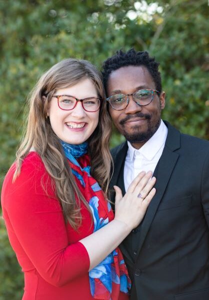 A man and woman in glasses posing for a photo.