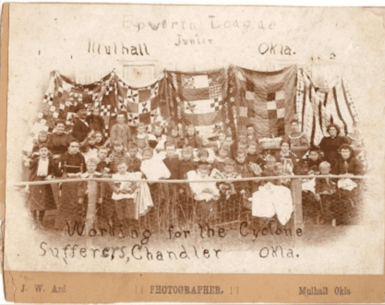 An old photo of a group of people with flags.