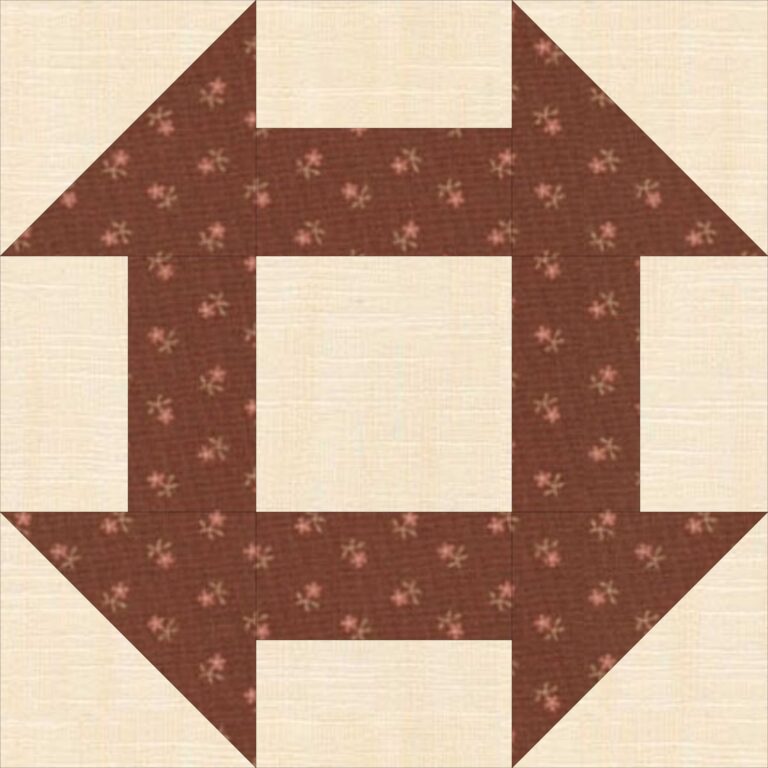 A quilt block with a brown flower design.