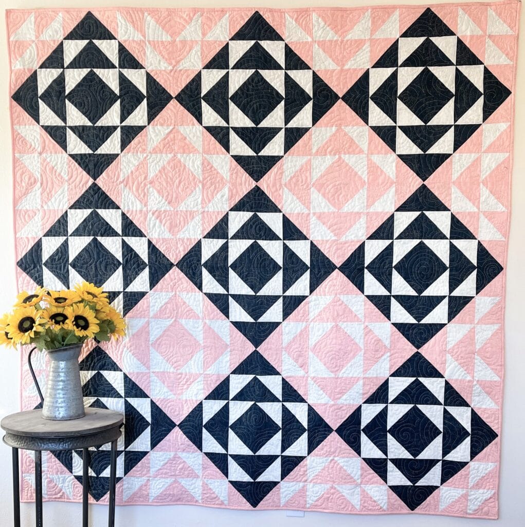 A quilt with black and white squares and sunflowers.