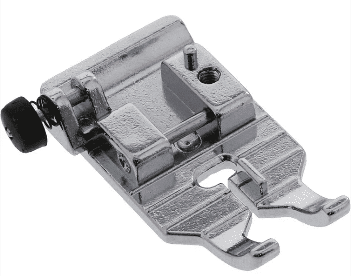 Metal sewing machine presser foot attachment.